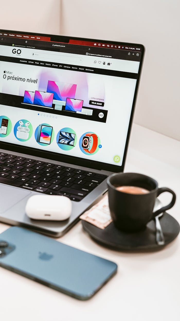 A stylish workspace featuring a laptop, smartphone, and coffee cup, embodying a modern tech lifestyle.